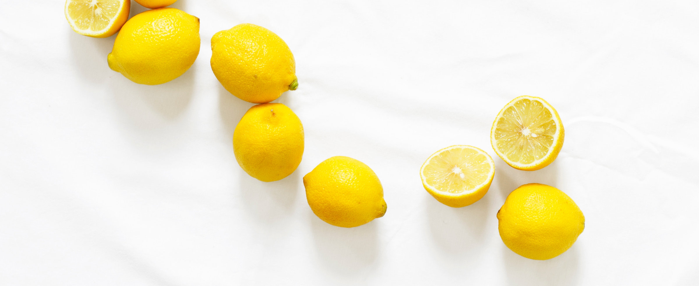 Lemons grown at the nursery laid out on a white surface